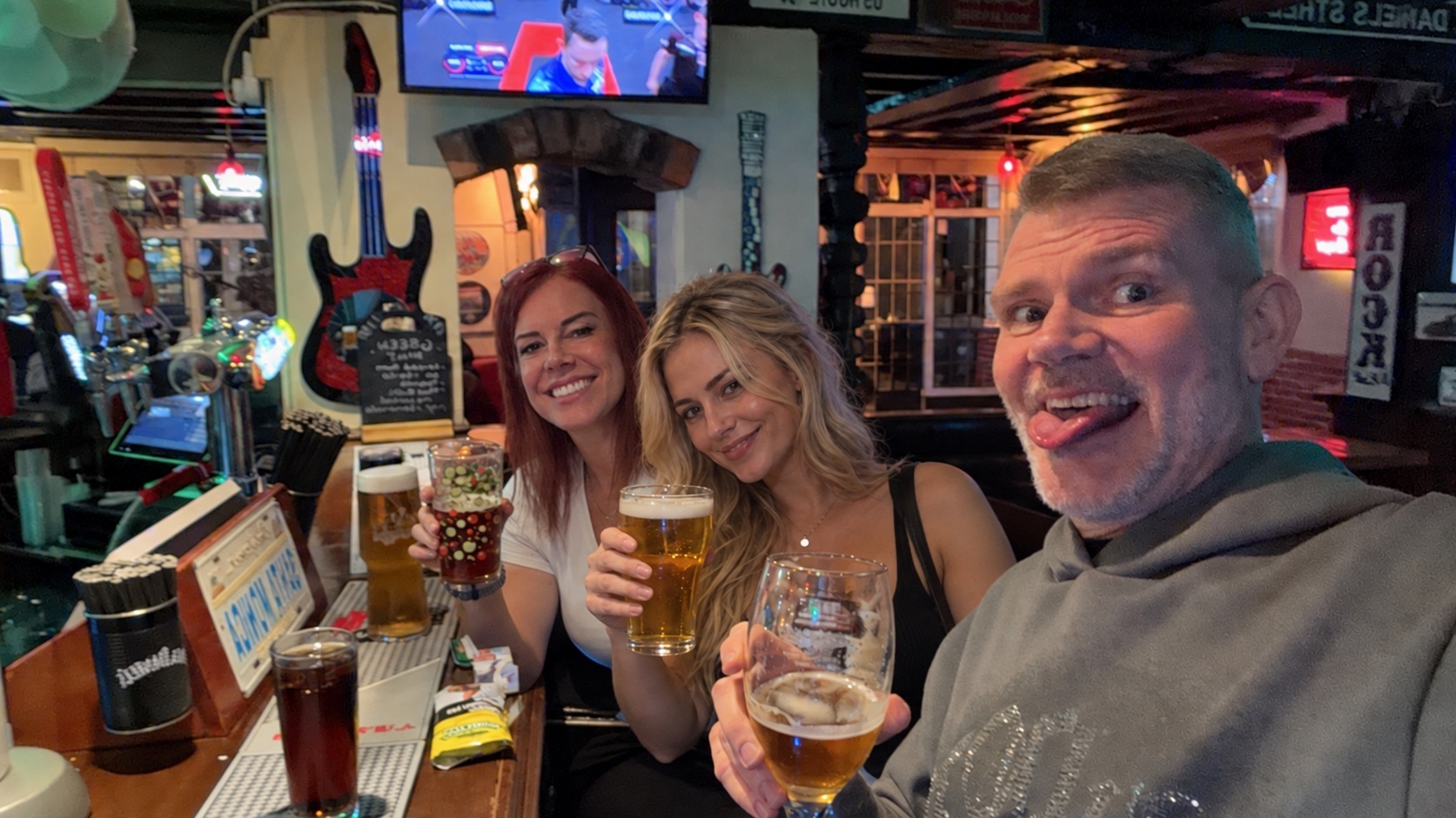 Jamie raising a glass with friends at The Globe